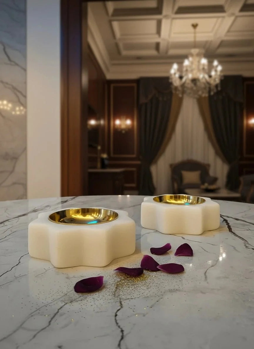 Handcrafted white marble and brass floral diyas for a Diwali dinner table setting