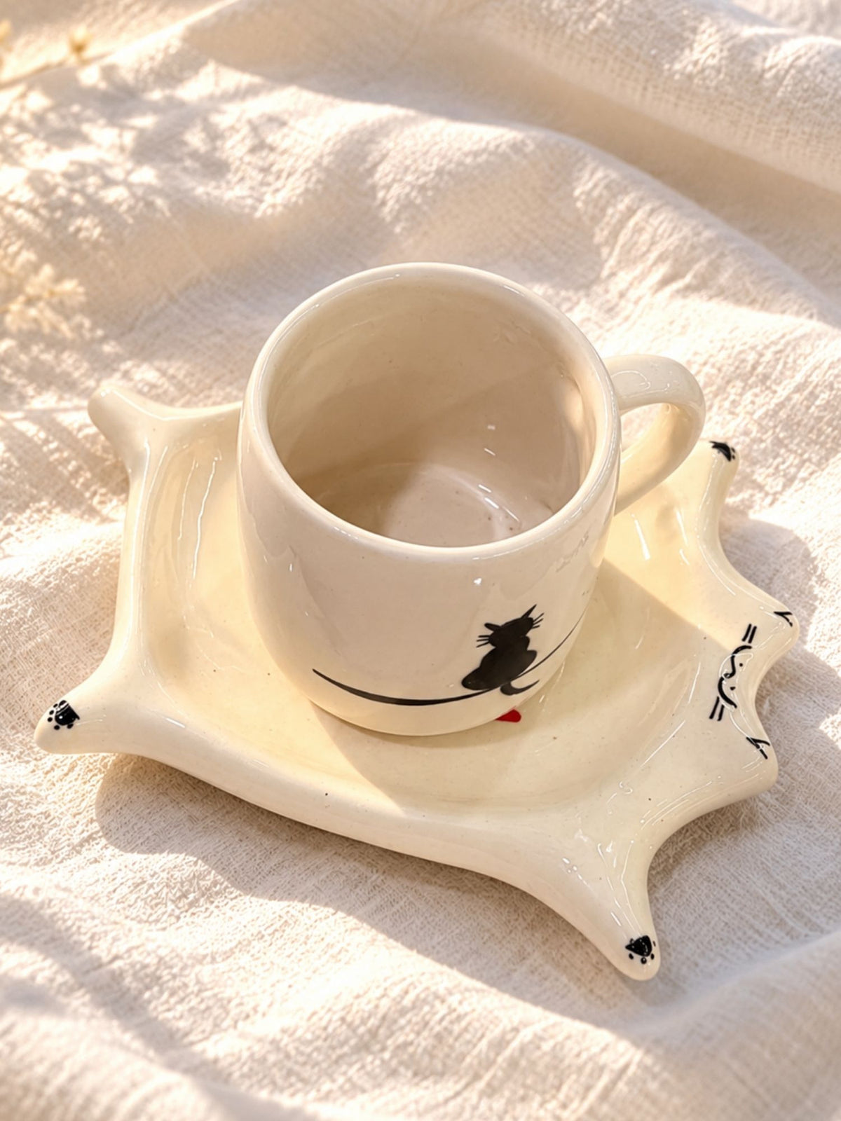 Cat cup and saucer set with black cat cup on cat-shaped ceramic saucer