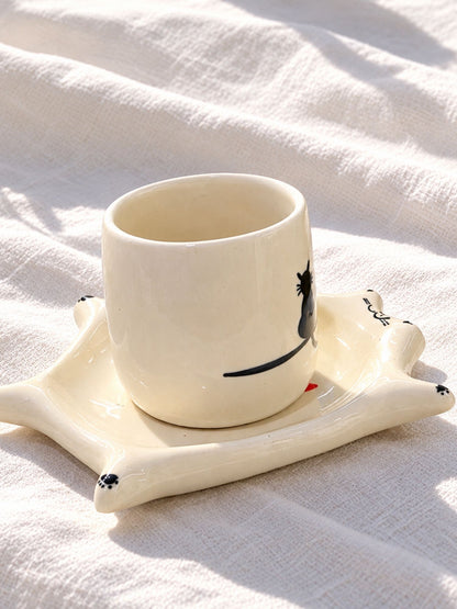 Hand-painted ceramic cup with black cat silhouette on cat saucer