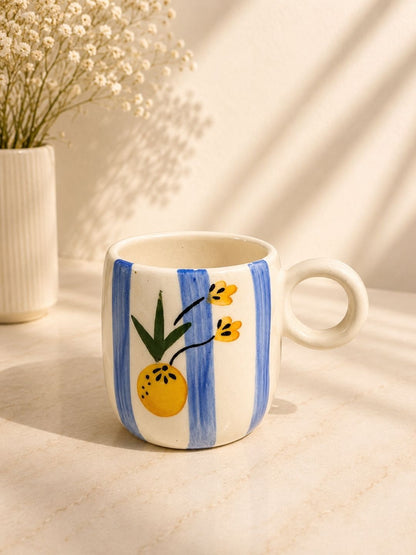 Handcrafted citrus floral ceramic coffee mug with hand-painted blue stripes made by Khurja artisans.