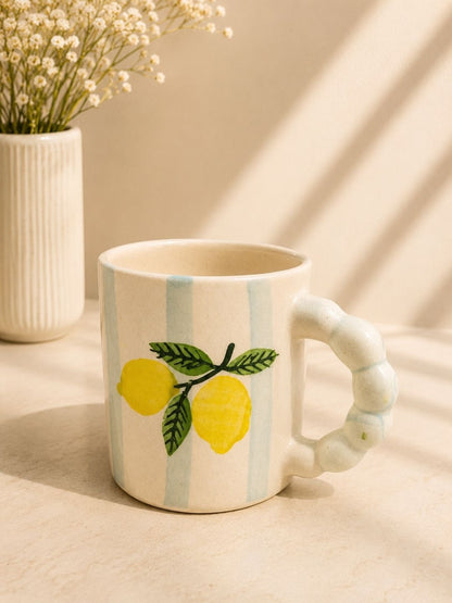Handcrafted lemon ceramic coffee mug with hand-painted lemon motifs and sculpted handle made by Khurja artisans.