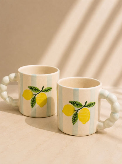 Hand-painted lemon coffee mug with sculpted handle by Chaak Design.