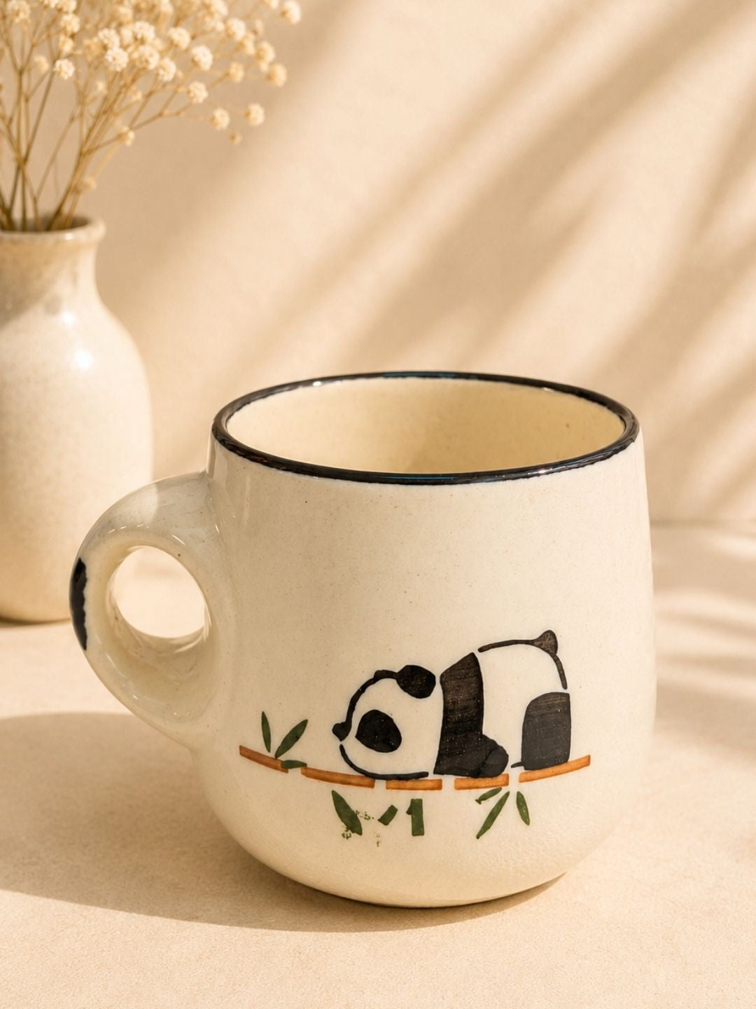 Ceramic mug with a panda design on a beige background