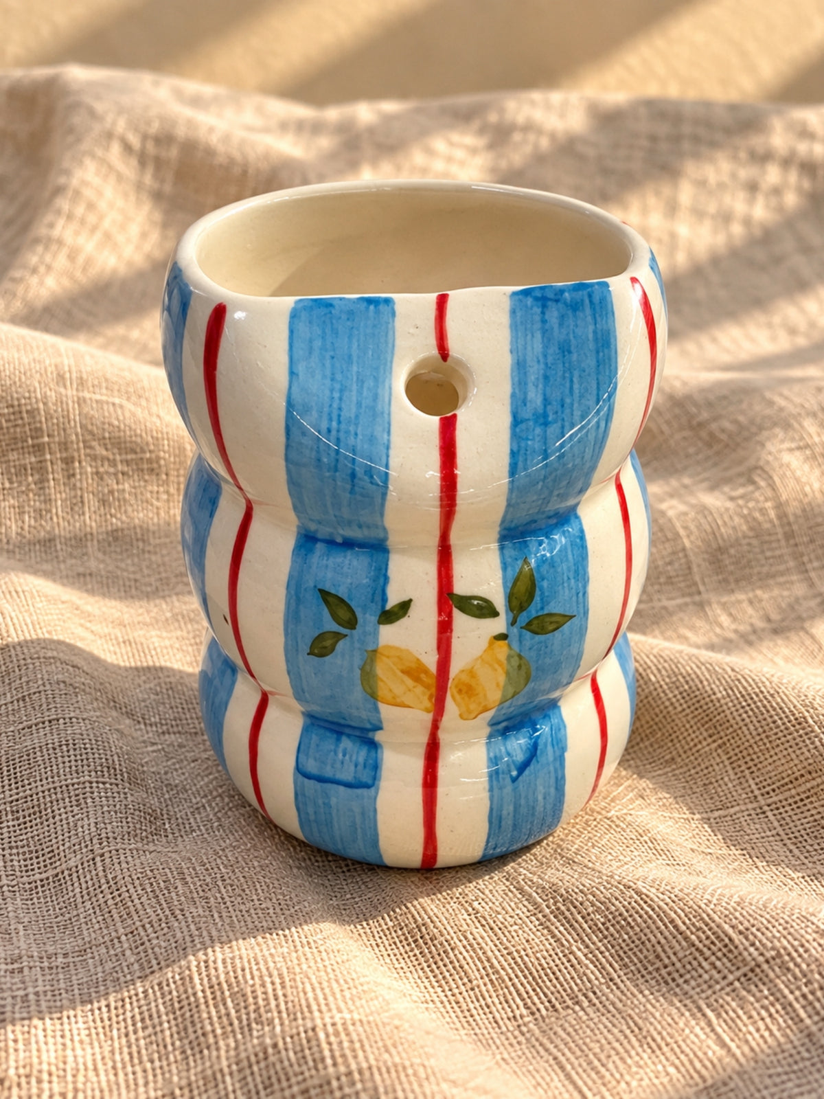 Front view of hand-painted lemon bubble tumbler showing built-in straw hole