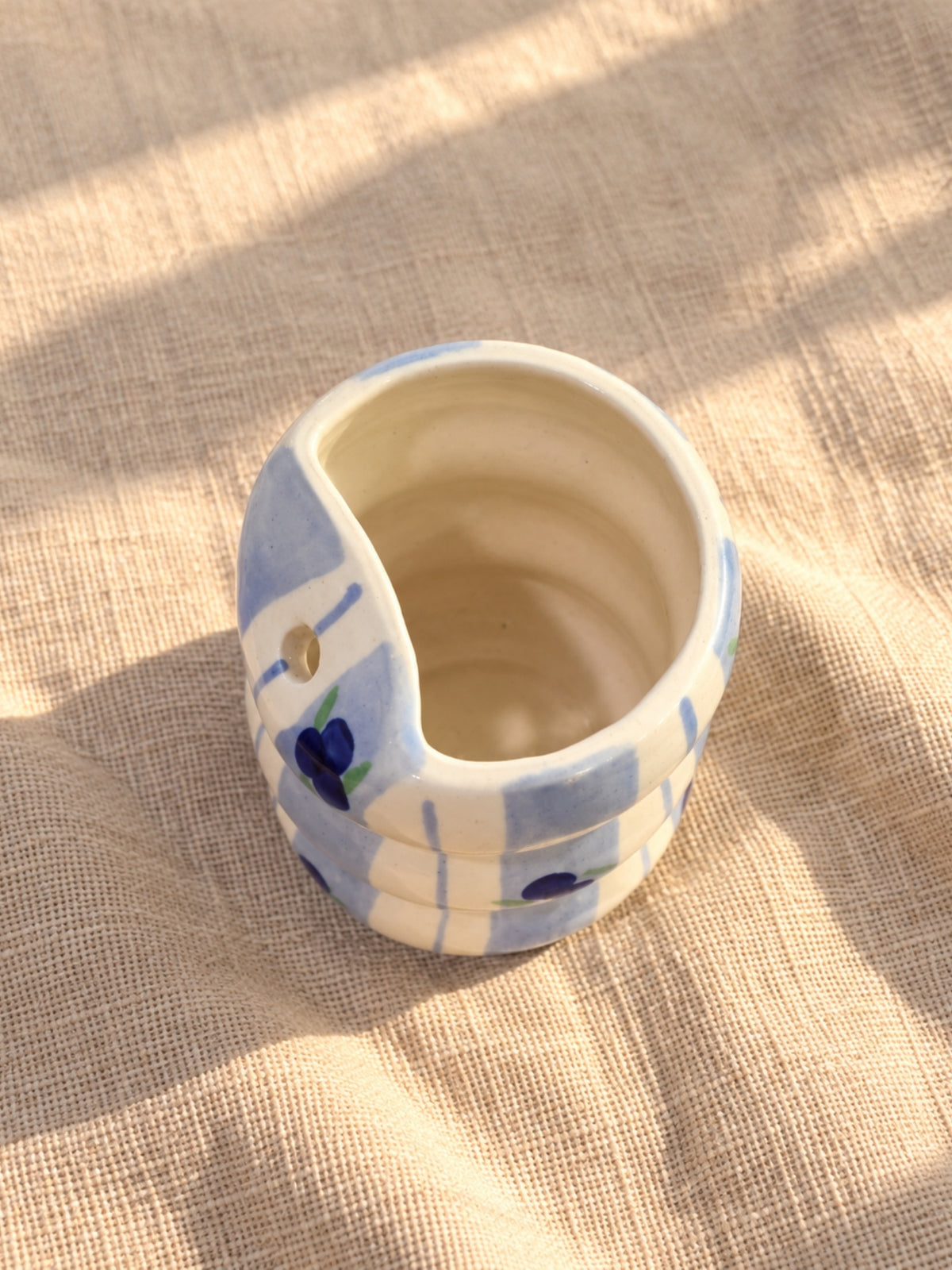 Top view of blueberry bubble tumbler with blue stripes and straw hole
