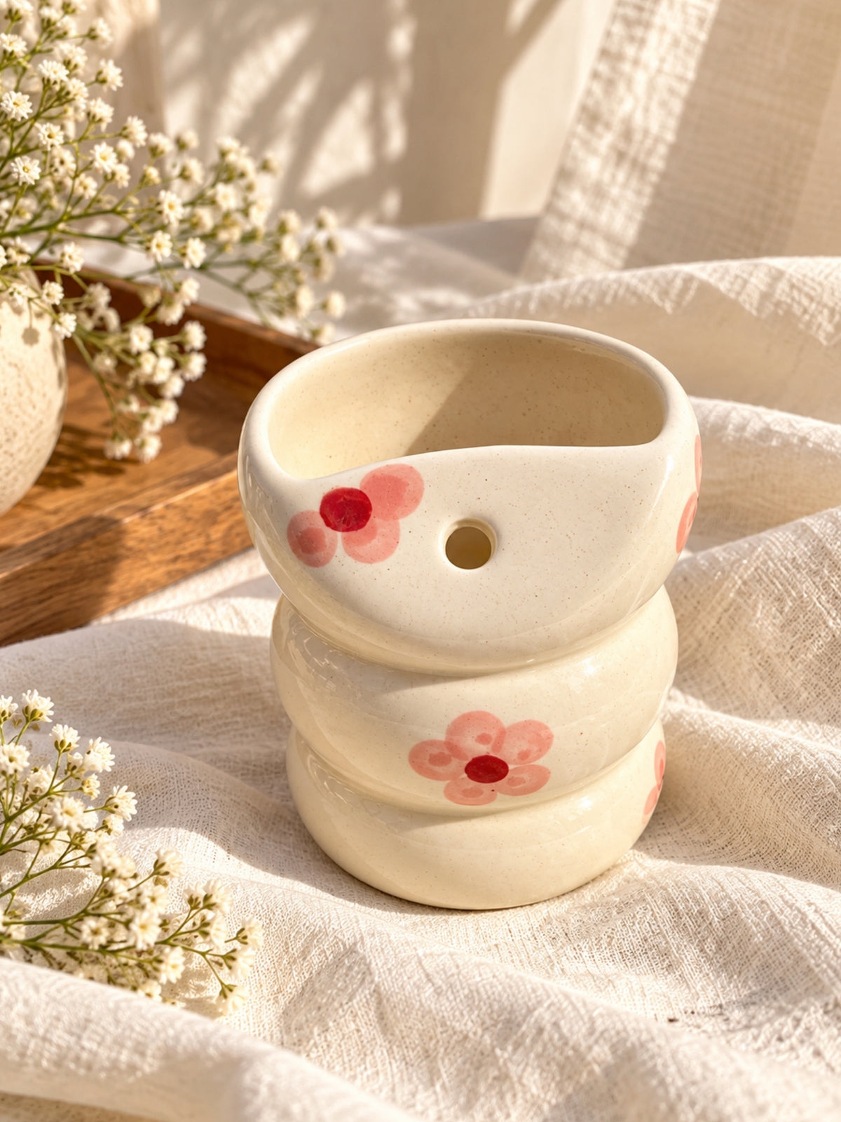 Pink flower ceramic bubble tumbler showing built-in straw hole